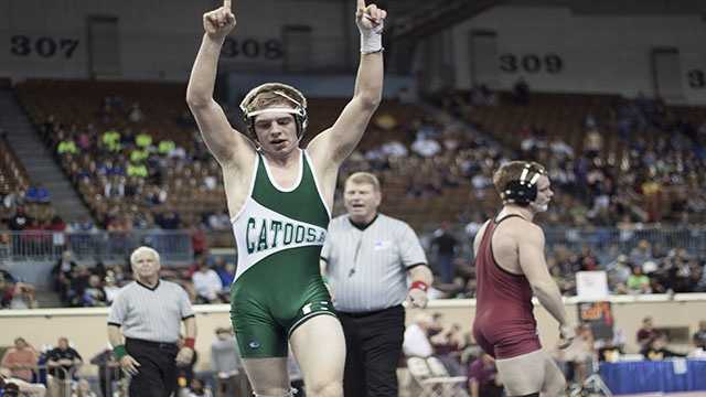 Victory Catoosa junior Darren Fowler raises his arms in victory after winning the Class 3A 145 lbs. consolation final and receiving third place.