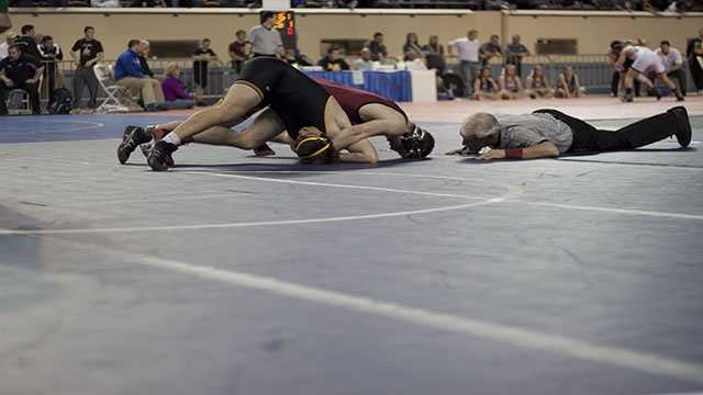 Trying to finish Tuttle's Austin Elam attempts to pin Luke Chapman of Madill during the 160 lbs. Class 4A consolation finals. Elam would win a 10-2 major decision for third place.