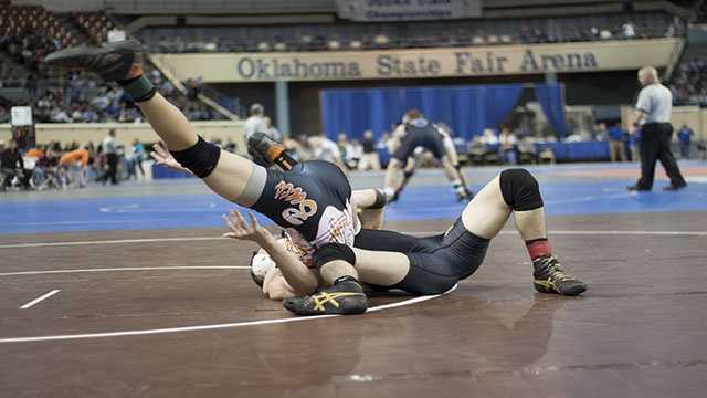 Rolled up Derick Shrum of Jay attempts a pin as he rolls up Gage Martin of Tonkawa during the CLass 3A 132 lbs. consolation finals.