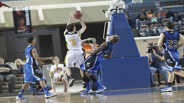 Let's get physical Arnett's Trevor Bryant (3) held nothing back as and Coyle's Tony Aska (21) collided near the basket.