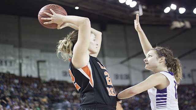 Won't back down Tana Craven (22) looks for a teammate as she is pinned in the corner by Okarche's Rae Grellner (13).
