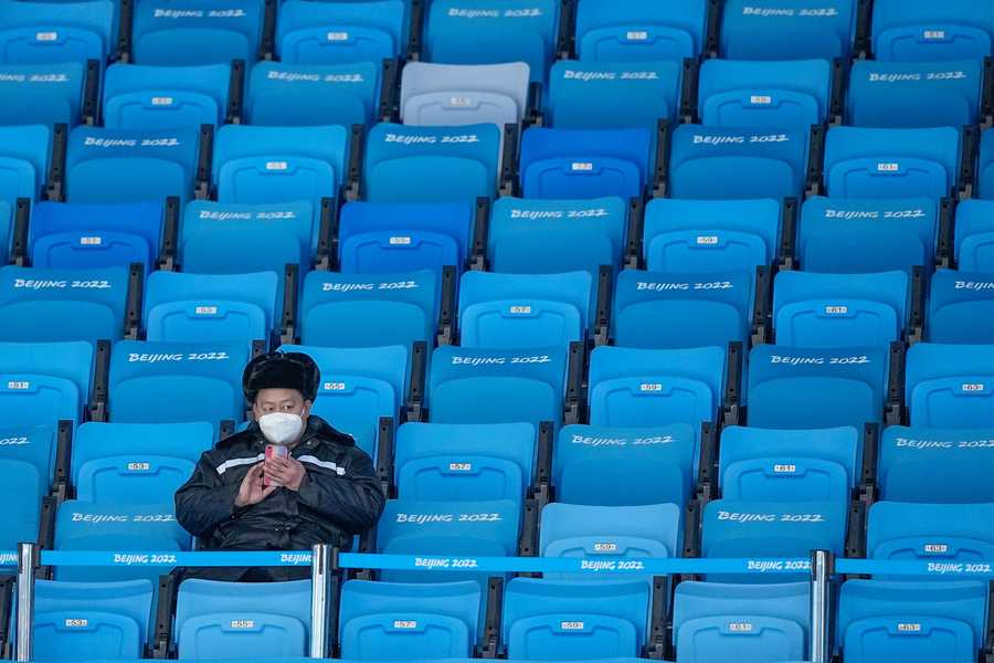 Beijing Olympics Getting A Glimpse Photo Gallery A lone fan waits for the start of the men's singles short program in the figure skating competition.