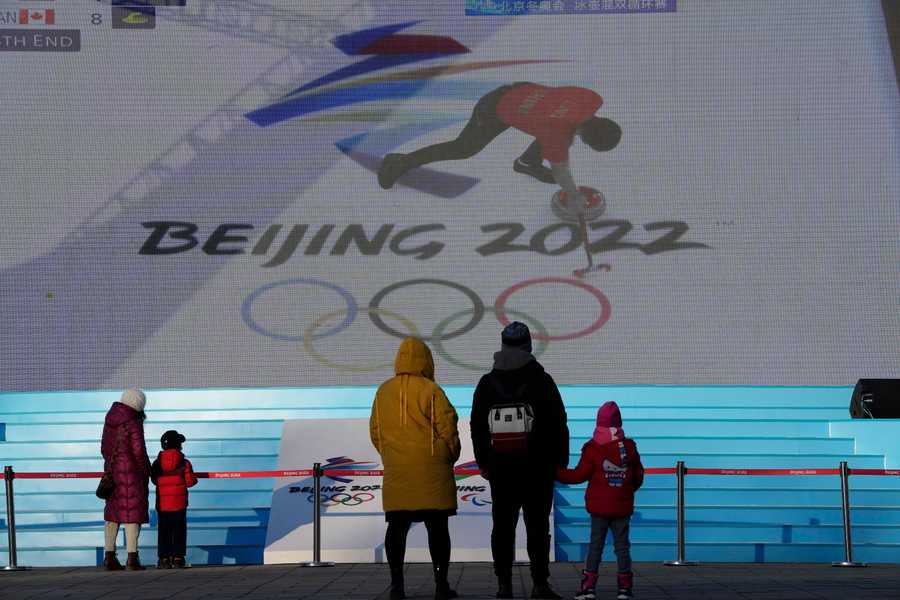 Beijing Olympics Getting A Glimpse Photo Gallery Residents watch a broadcast of a curling competition.