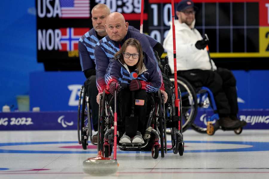 Paralympic Games Pamela Wilson of the United States pushes a stone as teammates Steve Emt and Dave Samsa assist during their wheelchair curling match against Norway at the 2022 Winter Paralympics, Monday, March 7, 2022, in Beijing.