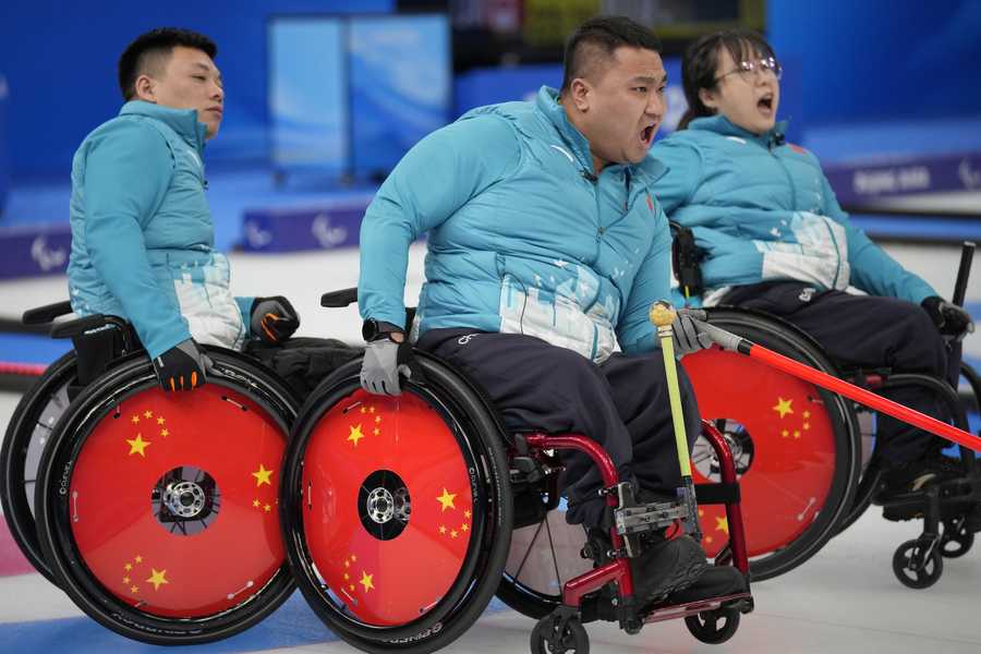Paralympic Games China's Wang Haitao, center, Yan Zhuo, right, and Zhang Mingliang react during their wheelchair curling match against Switzerland at the 2022 Winter Paralympics, Monday, March 7, 2022, in Beijing.