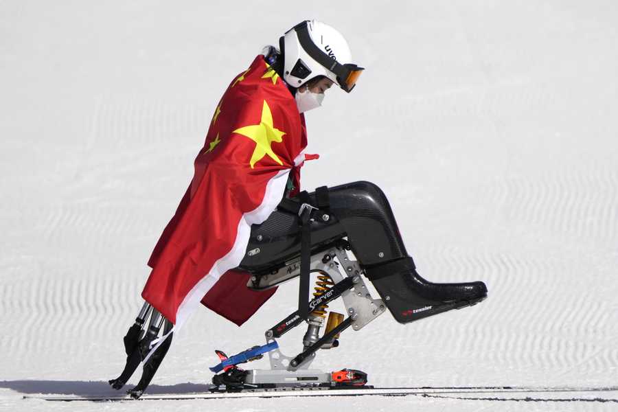 Paralympic Games Zhang Wenjing of China leaves after the flower ceremony in the women's super G, sitting, at the 2022 Winter Paralympics, Sunday, March 6, 2022, in the Yanqing district of Beijing.