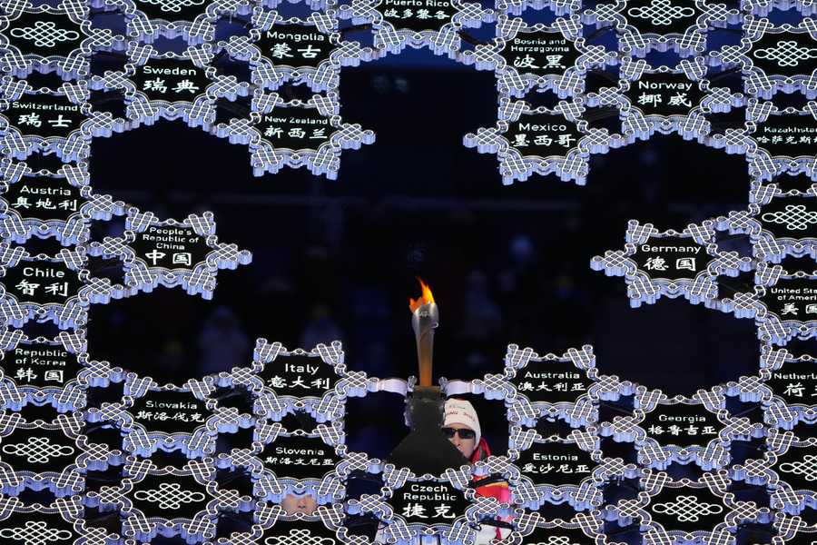 Paralympic Games Torchbearer and former Chinese Paralympian Li Duan lights the Paralympic flame during the opening ceremony at the 2022 Winter Paralympics, Friday, March 4, 2022, in Beijing.
